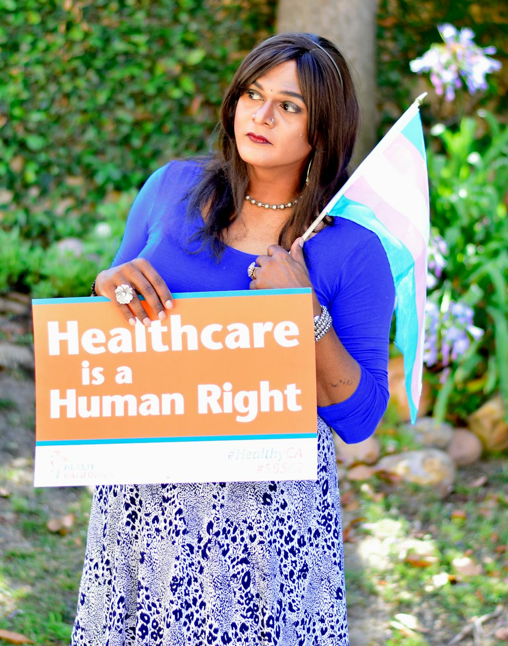 woman holding a poster and flag