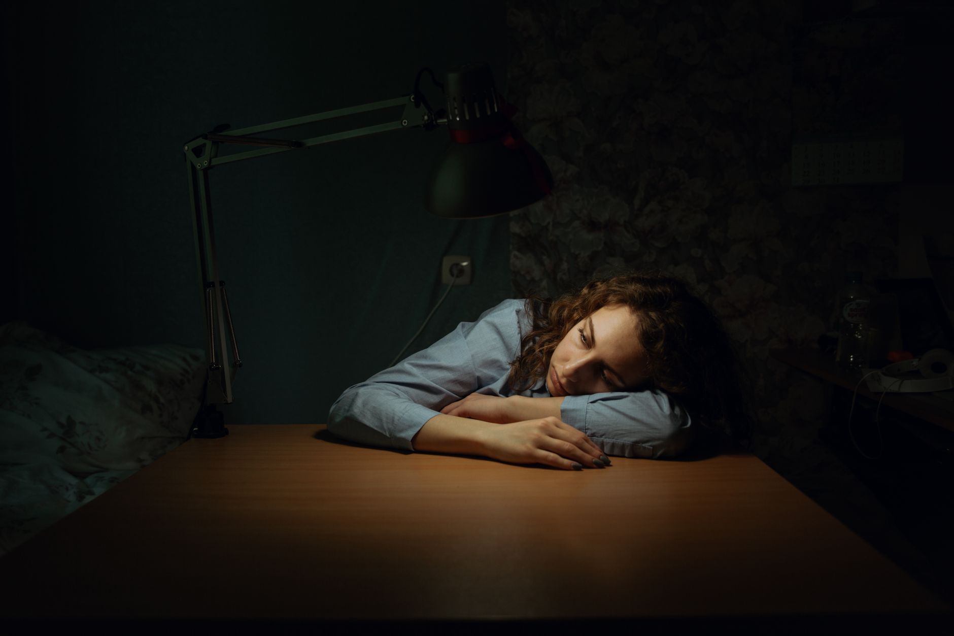 a woman lying on wooden desk